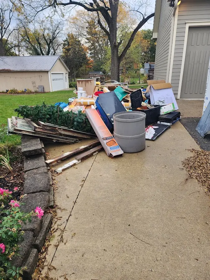 Dumpster being loaded with debris for Roofing Dumpster Rental in Elkin